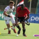 A Kenyan player going past his South African opponent